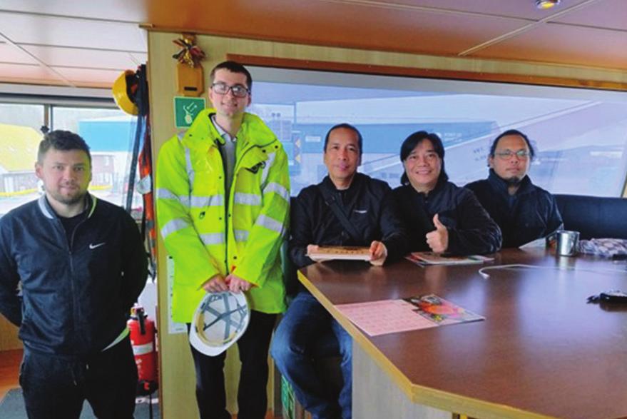 Lawrence Rabone alongside Filipino sailors and a Ukrainian seaman